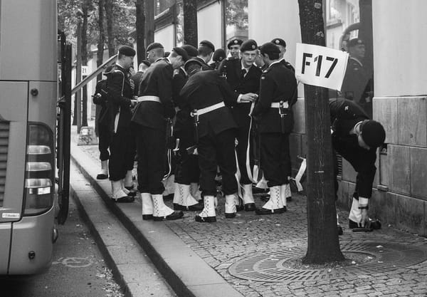 Royal guards gathered next to a bus
