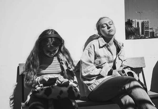 Woman sat in the sun with closed eyes