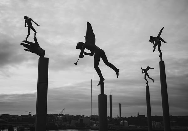 Sculpture silhouettes against sky