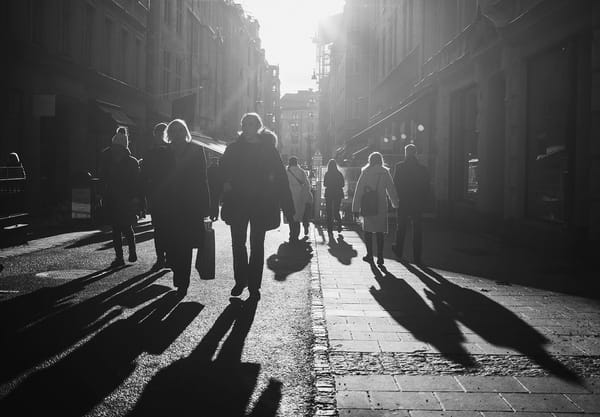 People and shadows in the street
