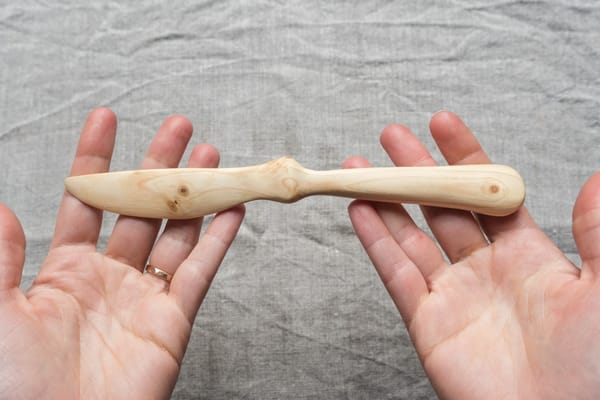 Wooden knife in hands